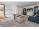 Finished basement with carpet, seating area, and staircase to another level at 661 Manchester Dr, Raleigh, NC 27609