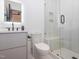 Modern bathroom with sleek vanity, toilet, and a glass-enclosed shower at 661 Manchester Dr, Raleigh, NC 27609