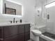 Modern bathroom featuring floating vanity with shower and glass door at 661 Manchester Dr, Raleigh, NC 27609