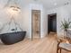Bright bathroom offers an oversized soaking tub and a marble-tiled walk-in shower at 661 Manchester Dr, Raleigh, NC 27609