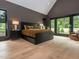 Bright bedroom boasts a large picture window, accent wall, and gleaming hardwood floors at 661 Manchester Dr, Raleigh, NC 27609