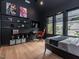This modern bedroom features hardwood floors, dark walls, and a wall mounted TV at 661 Manchester Dr, Raleigh, NC 27609