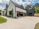 Spacious three car garage with black metal doors, providing ample parking and secure storage at 661 Manchester Dr, Raleigh, NC 27609