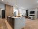 Bright kitchen with large island, undermount sink, and stainless steel appliances in an open floorplan at 661 Manchester Dr, Raleigh, NC 27609