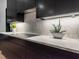 Modern kitchen features sleek dark cabinetry, quartz countertops, and stylish under cabinet lighting at 661 Manchester Dr, Raleigh, NC 27609