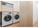 Bright laundry room with stainless steel washer and dryer at 661 Manchester Dr, Raleigh, NC 27609