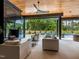 Modern living room with black fireplace, comfortable seating, and a view of the pool area at 661 Manchester Dr, Raleigh, NC 27609