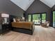 Primary bedroom with vaulted ceilings, large windows, and modern decor at 661 Manchester Dr, Raleigh, NC 27609