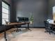 Office space featuring dual monitors, a sleek wooden desk, and natural light at 661 Manchester Dr, Raleigh, NC 27609