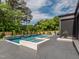 Stunning pool area with a spa and lush landscaping, perfect for outdoor relaxation and entertaining at 661 Manchester Dr, Raleigh, NC 27609