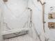 Large marble shower features dual shower heads, a built-in bench, and glass door at 661 Manchester Dr, Raleigh, NC 27609