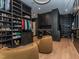 Expansive walk-in closet boasts custom shelving, dual seating, and hardwood flooring at 661 Manchester Dr, Raleigh, NC 27609