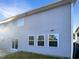View of the side and back exterior of the home showing windows and siding at 664 Lavenham Ln, Fuquay Varina, NC 27526