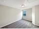 Bedroom with neutral walls and grey carpet and window at 664 Lavenham Ln, Fuquay Varina, NC 27526