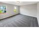 Large carpeted bedroom with big windows at 664 Lavenham Ln, Fuquay Varina, NC 27526