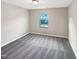 Bedroom with neutral walls, grey carpet, and window with backyard view at 664 Lavenham Ln, Fuquay Varina, NC 27526