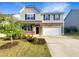 Charming two-story home with a landscaped front yard and a two-car garage at 664 Lavenham Ln, Fuquay Varina, NC 27526