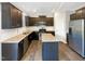 Spacious kitchen featuring granite countertops, stainless steel appliances, and dark cabinetry at 664 Lavenham Ln, Fuquay Varina, NC 27526