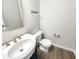 Powder room featuring hardwood style floors, a sink, and a toilet at 664 Lavenham Ln, Fuquay Varina, NC 27526