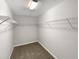 Empty walk-in closet with wire shelving and neutral carpet at 664 Lavenham Ln, Fuquay Varina, NC 27526