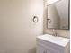 Bright bathroom featuring a white vanity with silver faucet and framed mirror at 7408 Sandy Creek Dr, Raleigh, NC 27615