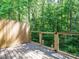 Wood deck with black metal fencing looking out at the woods at 7408 Sandy Creek Dr, Raleigh, NC 27615