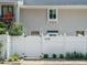 Charming exterior with white picket fence and neat landscaping adds curb appeal to the property at 7408 Sandy Creek Dr, Raleigh, NC 27615