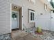 Inviting front entrance featuring a wreath and well-maintained landscaping around the walkway at 7408 Sandy Creek Dr, Raleigh, NC 27615