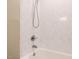 Bathtub and shower combo with white marble tile at 7408 Sandy Creek Dr, Raleigh, NC 27615
