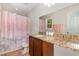 Bathroom featuring granite countertops, dark wood cabinetry, and a shower-tub combination at 776 Averasboro Dr, Clayton, NC 27520