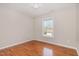 Bedroom with gleaming hardwood floors and a window letting in natural light at 776 Averasboro Dr, Clayton, NC 27520