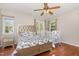 Comfortable bedroom with hardwood floors, a large bed, and a crib in the corner near the windows at 776 Averasboro Dr, Clayton, NC 27520