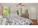 Comfortable bedroom featuring a bed with decorative pillows, hardwood floors, and large windows at 776 Averasboro Dr, Clayton, NC 27520