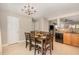 Dining area with a dark wood table and seating for six, stainless steel appliances, and tile flooring at 776 Averasboro Dr, Clayton, NC 27520