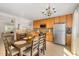 Bright kitchen with wood cabinets, stainless steel appliances, and a dining area with a modern chandelier at 776 Averasboro Dr, Clayton, NC 27520