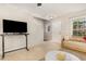 Cozy living room with a large TV, comfortable seating, and views into the staircase and front door at 776 Averasboro Dr, Clayton, NC 27520