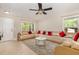 Inviting living room with a ceiling fan, a large window, and comfortable L-shaped seating at 776 Averasboro Dr, Clayton, NC 27520