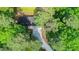Aerial view of house, long driveway and treed lot at 9614 Quail Roost Rd, Bahama, NC 27503