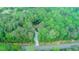 Aerial view of the house on a lot in the woods at 9614 Quail Roost Rd, Bahama, NC 27503