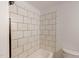 Close up of the tiled shower and toilet in the bathroom at 9614 Quail Roost Rd, Bahama, NC 27503