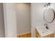 Bright, spacious bathroom with wood-grained vanity, vessel sink, round mirror and wood-look floors at 9614 Quail Roost Rd, Bahama, NC 27503