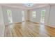 Spacious bedroom with hardwood floors and an abundance of natural light from multiple windows at 9614 Quail Roost Rd, Bahama, NC 27503