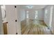 Sunlit bedroom featuring wood floors, windows, and painted walls at 9614 Quail Roost Rd, Bahama, NC 27503
