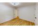 Bright bedroom with double closet doors, white walls, wood-look floors and modern light fixture at 9614 Quail Roost Rd, Bahama, NC 27503