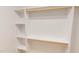 Organized closet with white shelving and wooden closet rods, offering ample storage space at 9614 Quail Roost Rd, Bahama, NC 27503