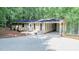 Charming home exterior with a large driveway and covered parking at 9614 Quail Roost Rd, Bahama, NC 27503