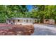 Charming ranch-style home with a well-manicured lawn, a covered front entrance, and detached shed at 9614 Quail Roost Rd, Bahama, NC 27503