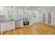 Modern kitchen featuring stainless steel appliances, white cabinets, granite countertops, and natural lighting at 9614 Quail Roost Rd, Bahama, NC 27503