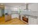 Modern kitchen featuring stainless steel appliances, white cabinets, and beautiful subway tile backsplash at 9614 Quail Roost Rd, Bahama, NC 27503