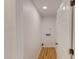 Interior laundry room with white walls, door, and wood-look floors at 9614 Quail Roost Rd, Bahama, NC 27503